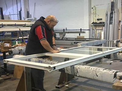 Engineer constructing a set of aluminium doors